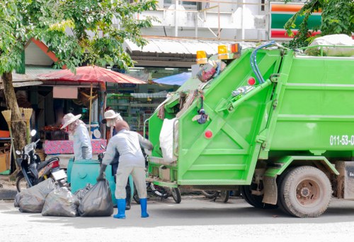 Electric van loading segregated office rubbish for sustainable disposal